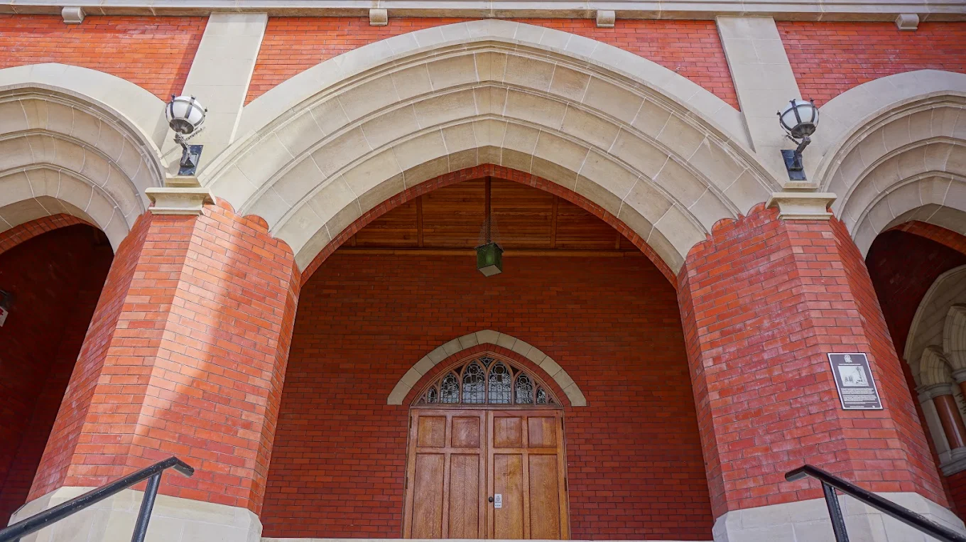 The triple-arched entrance porch and the oak doors of First Presbyterian Church